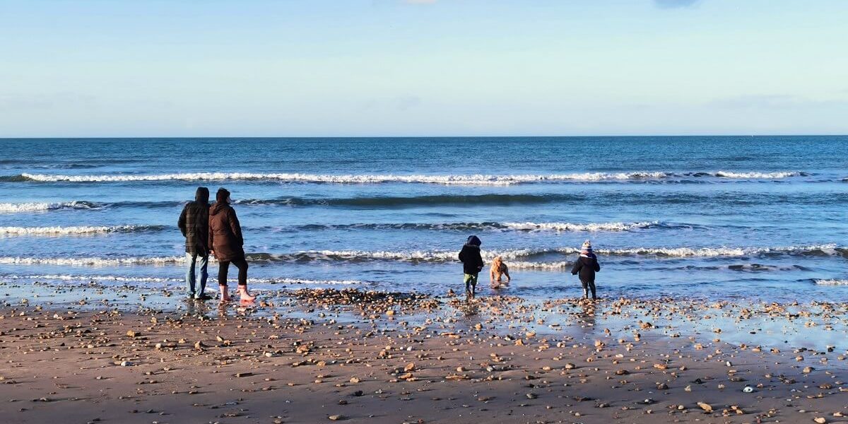 gezin met kinderen op het strand in de winter